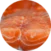 Close-up view of several slices of raw salmon, showing the detailed orange and white marbling in a circular frame.