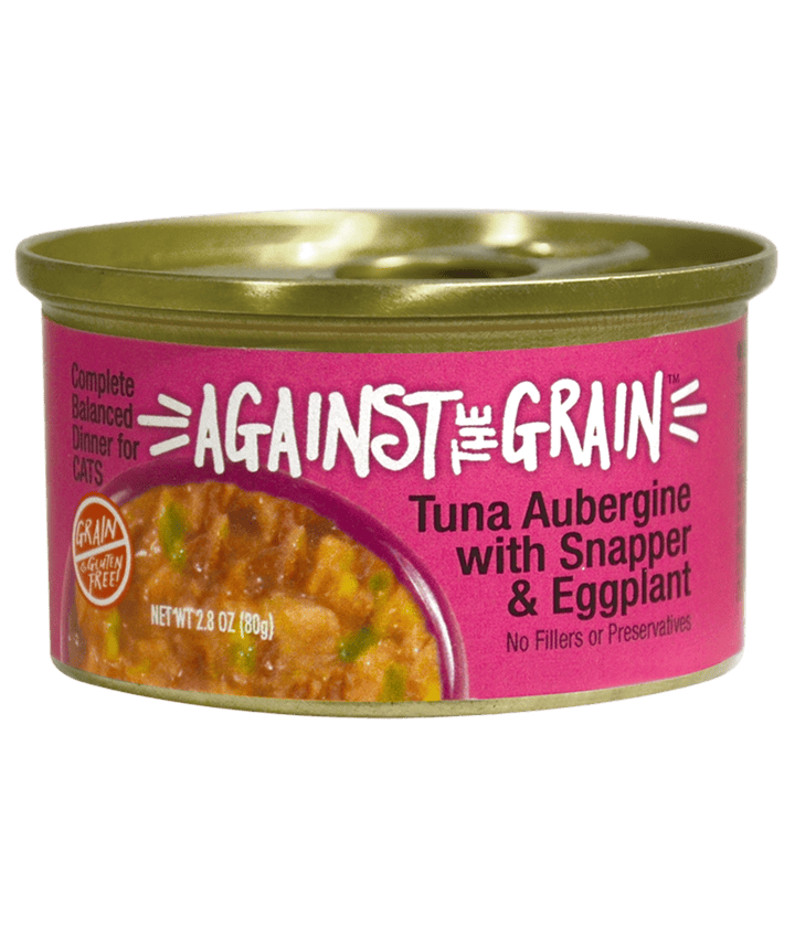 A can of Against the Grain cat food labeled "Aloha Tuna with Crab & Seaweed," featuring a gold lid and a pink label with text and food imagery.