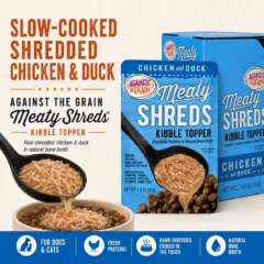 A spoon adds Shreds Slow Cooked Shredded Chicken & Duck Kibble Topper to a bowl of kibble, with the product’s packaging for Shreds Slow Cooked Shredded Chicken & Duck Kibble Topper displayed nearby.