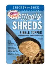 A blue pouch of "Shreds Slow Cooked Shredded Chicken & Duck Kibble Topper" for dogs, featuring shredded meat in broth being poured over kibble. Net weight: 2.8 oz (80g).