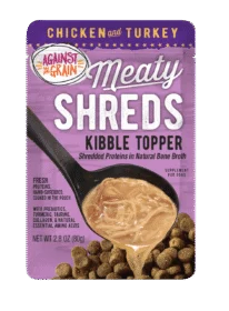 A pouch of Shreds Slow Cooked Shredded Chicken & Turkey Kibble Topper, featuring shredded meat in broth poured over dog kibble.