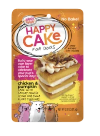A package of Happy Cakes for Dogs featuring layers of chicken and pumpkin cake, savory mousse, icing, and topped with tuna flakes. The orange packaging displays cartoon dogs and product details.