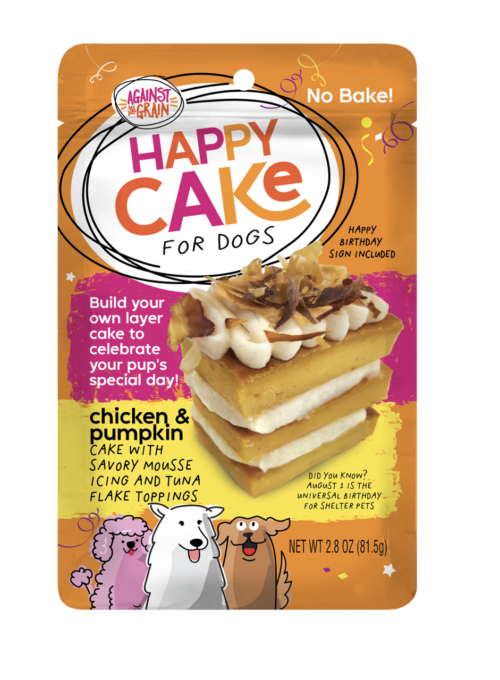 A package of Happy Cakes for Dogs featuring layers of chicken and pumpkin cake, savory mousse, icing, and topped with tuna flakes. The orange packaging displays cartoon dogs and product details.