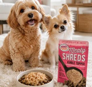 Two dogs alongside a pouch of Against the Grain shreds.