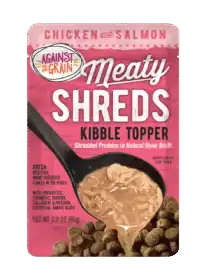 A pouch of Shreds Slow Cooked Shredded Chicken & Salmon Kibble Topper for dogs, showing shredded meat in broth being poured over kibble.